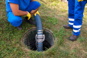 Two Pipe Doctor Technicians unblocking a sewer drain
